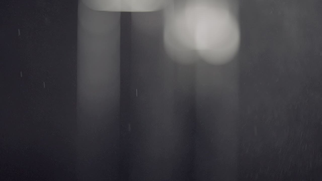 Misty spray descends from top to bottom with bokeh background