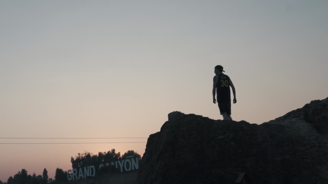 Silhouette of young man on walking on edge of cliff, Krabi Thailand