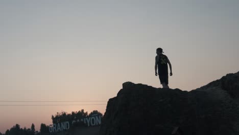 silhouette of young man on walking on edge of cliff, krabi thailand