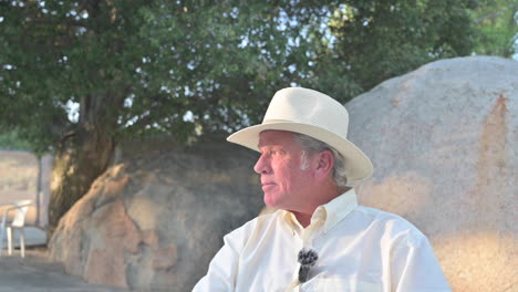 portrait of aged handsome attractive male sitting outside enjoying retirement