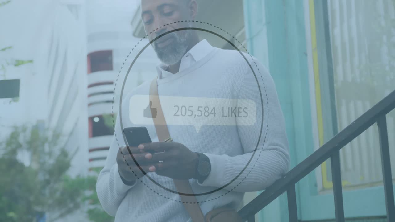 Thumbs up icon with increasing likes against african american senior man using smartphone