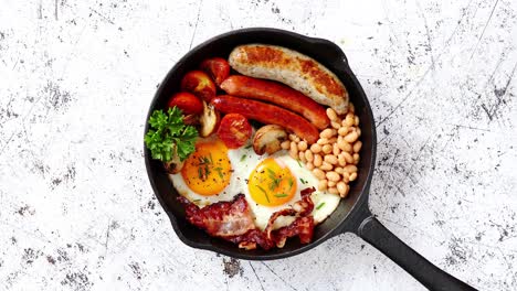 delicious english breakfast in iron cooking pan