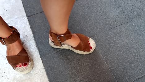 female feet showing a broken sandal after a long walk