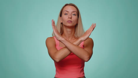 Woman-say-no-hold-palm-folded-crossed-hands-in-stop-gesture,-warning-of-finish,-prohibited-access