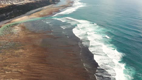 high flyover pantai pandawa beach resort bali indonesia colorful sandy beach with red volcano sand