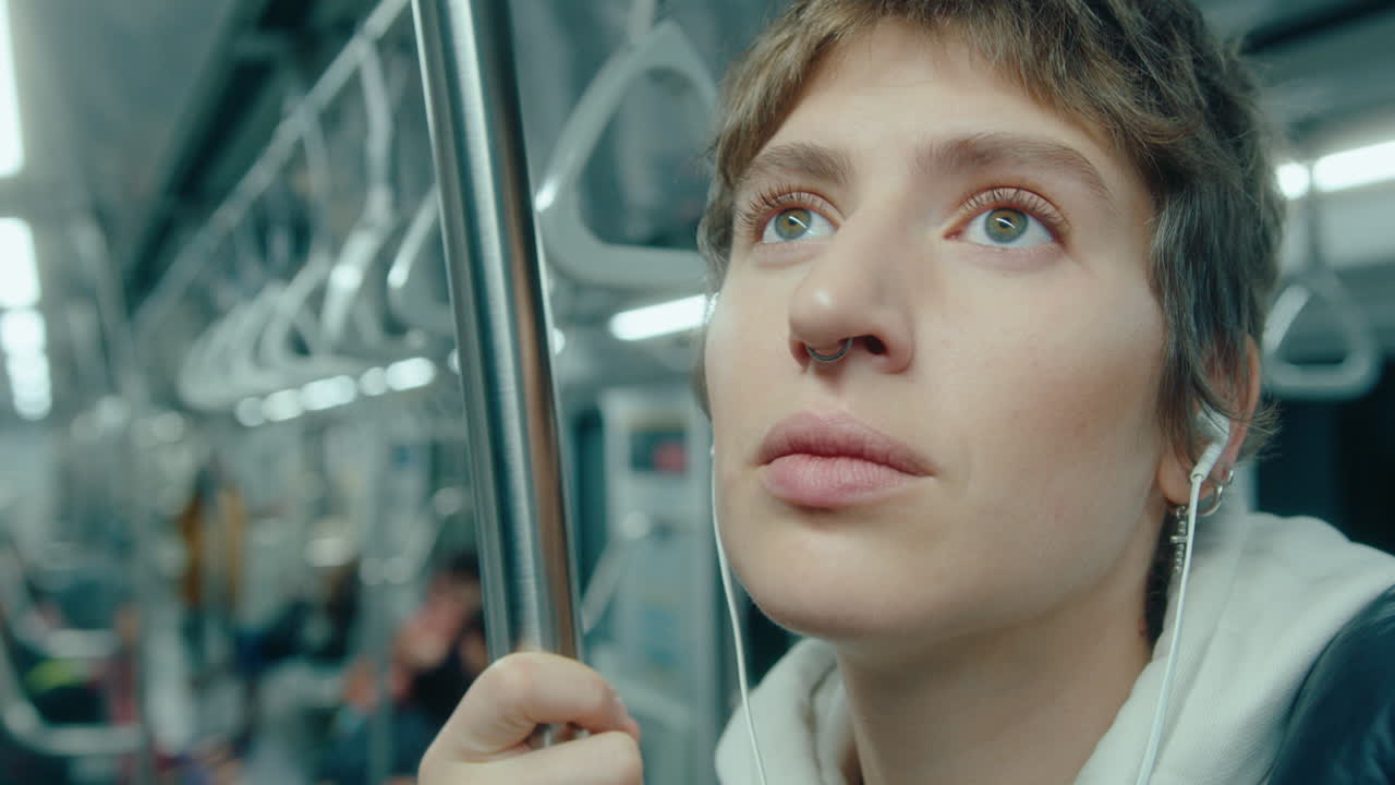 Girl in Earphones Riding the Subway
