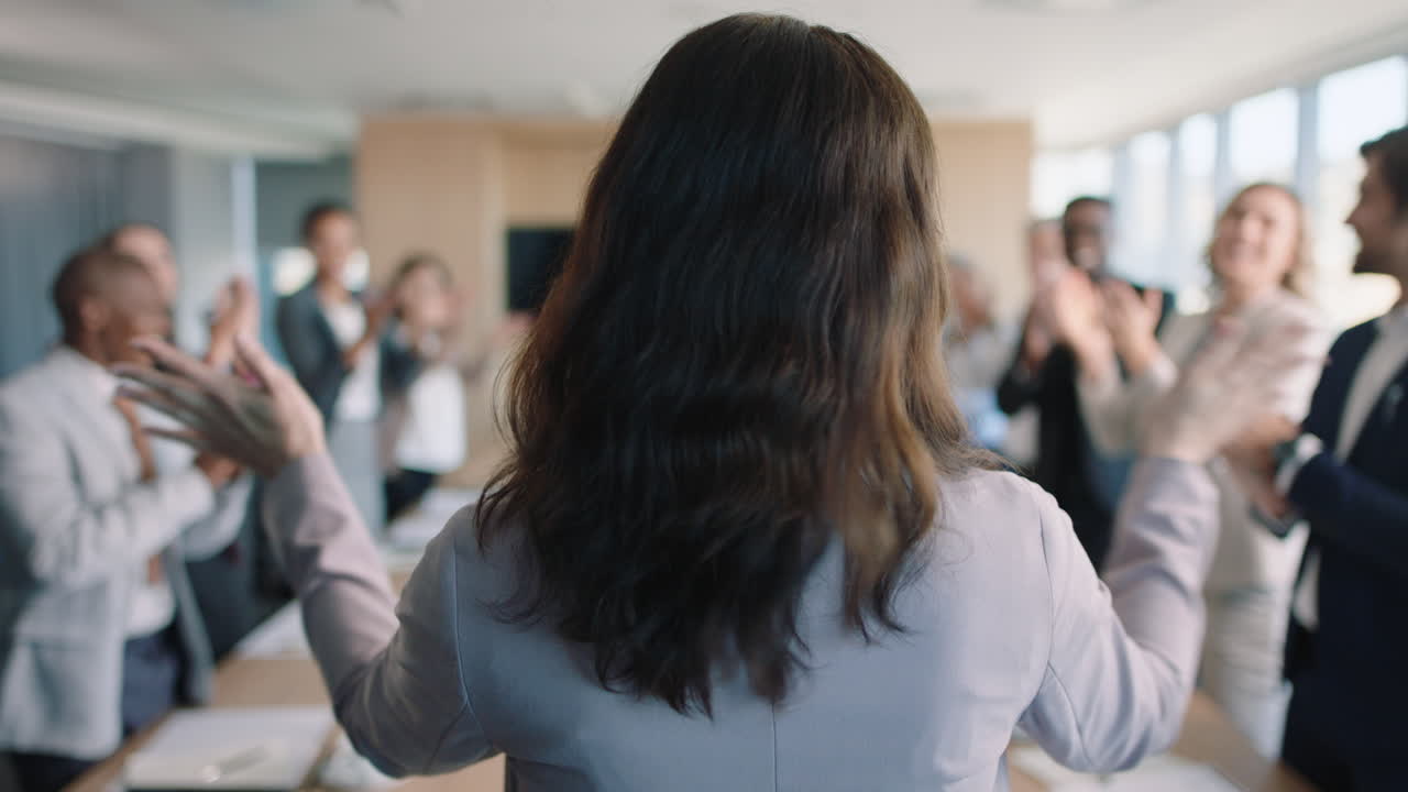 rear view business people celebrating congratualting happy business woman presenting successful solution to shareholders clapping hands applause in office boardroom meeting 4k