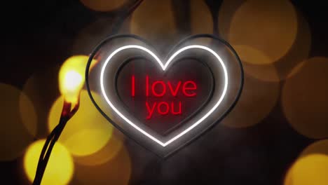 Animation-of-words-i-love-you-in-red-with-yellow-neon-hearts-flashing-with-bokeh-yellow-lights