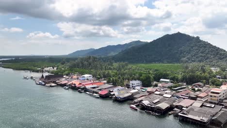 fishing village with traditional huts in koh lanta island, thailand. aerial pull back, landscape