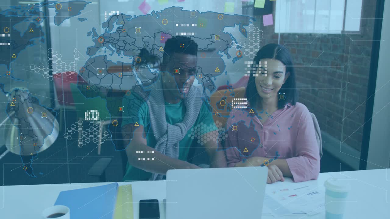Man typing on laptop and pointing at screen as woman adjusting chart with technology map emerging