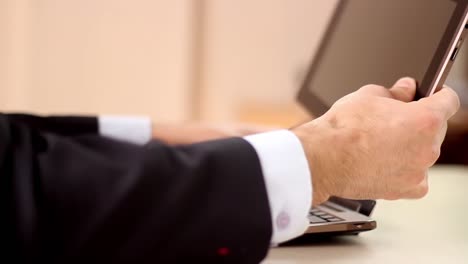 Businessman-Using-Tablet-And-Laptop