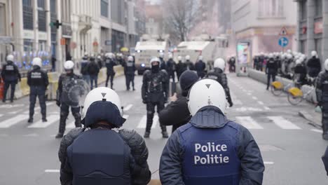 Shameless-male-person-and-his-dog-filming-riot-police-officers,-water-canon-and-riots-in-the-city