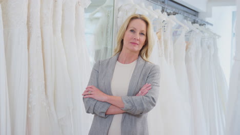 Portrait-Of-Smiling-Mature-Female-Owner-Of-Bridal-Wedding-Dress-Shop