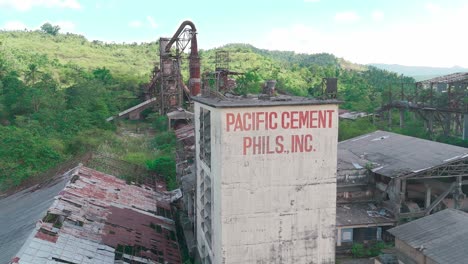 Abandoned-factory-building-in-middle-of-the-valley-pan-shot-left-to-right