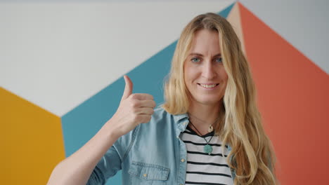 woman smiling and giving a thumbs up