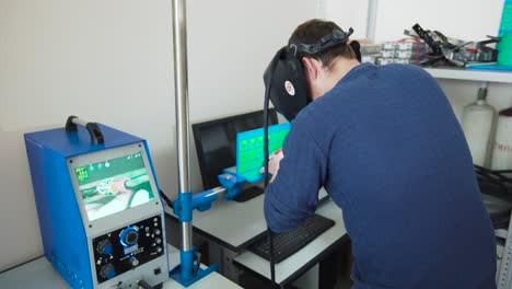 technician performing precise welding on circuit boards