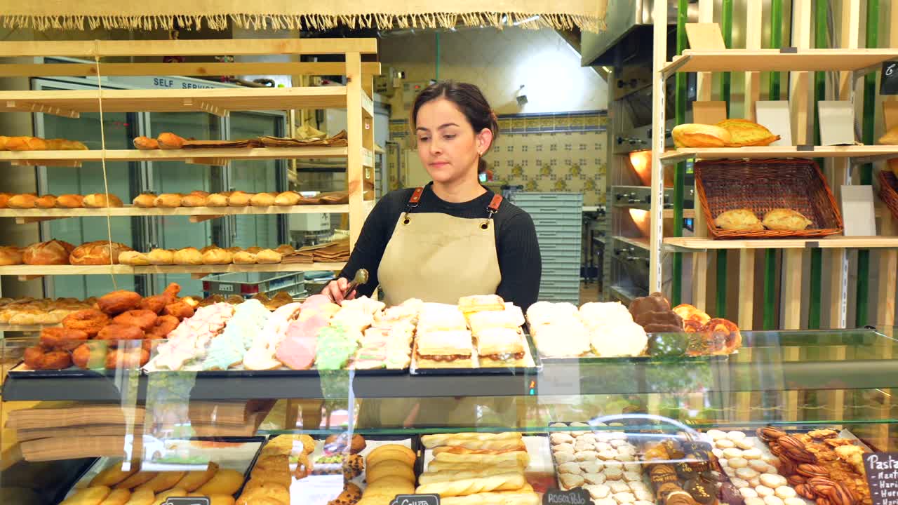 Woman in a bakery with pastries and bread