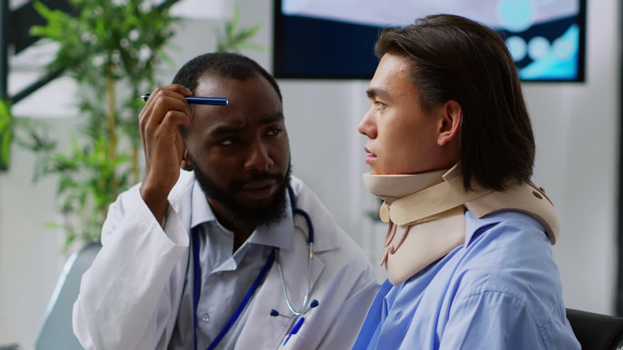 Doctor examining patient with neck brace
