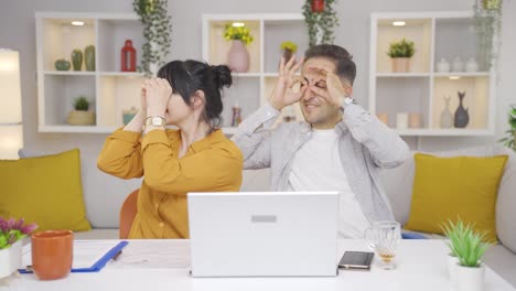 couple making binoculars with their hands. search state.