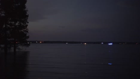 boats on the calm water in the dark