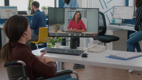 immobilized entrepreneur talking with coworker during video conference