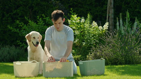 man doing laundry outdoors with his dog