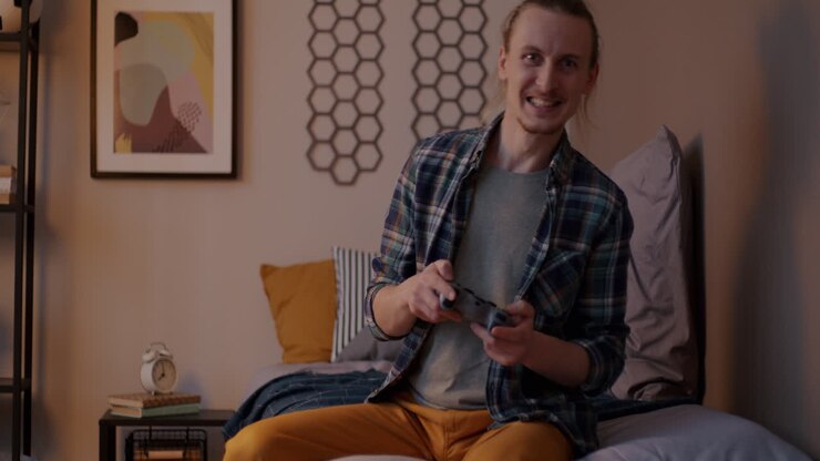 Man Playing Video Games in His Bedroom
