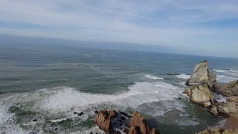 Panning-over-Praia-da-Ursa-beach-and-cliffs-near-Cabo-da-Roca-Portugal