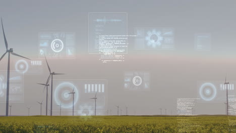 wind turbines in field with digital data processing animation over landscape