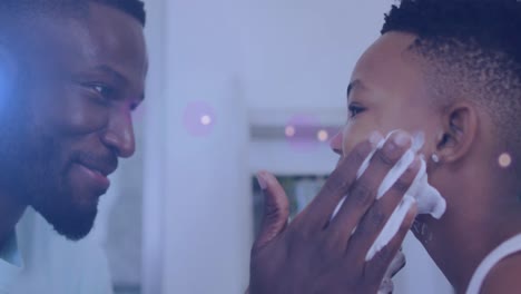 animación de luces sobre un feliz padre y hijo afroamericanos afeitándose la barba
