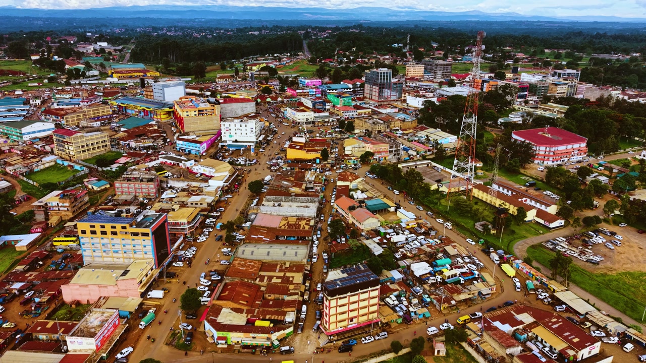 Aerial flyover poor Kitale Slum and modern skyline of Kitale rural urban area of kenya during sunny day. Two class society in Africa.