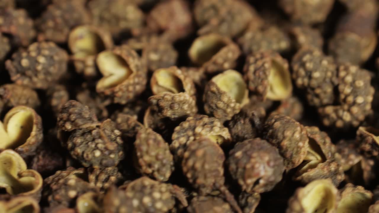 Dried black pepper close-up macro. A bunch of natural black pepper peas hot spice. Seasonings and condiments concept. High quality 4k footage
