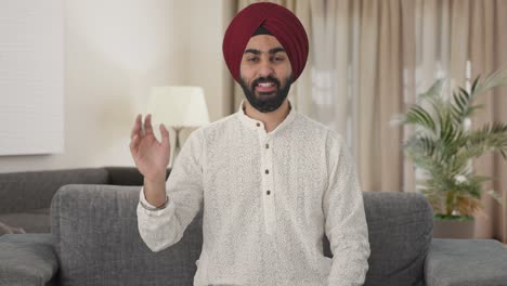 happy sikh indian man waving hello