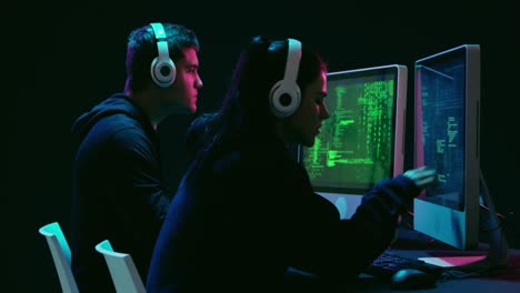 Man and woman working on computers