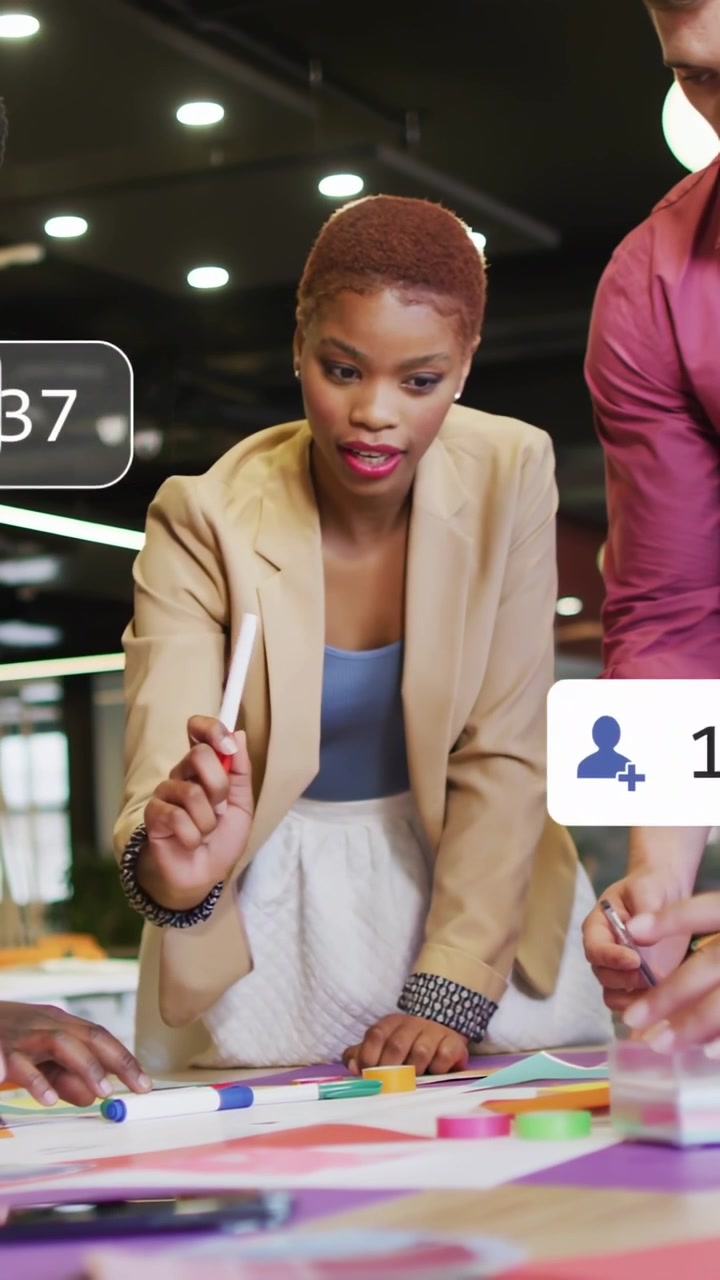 Vertical video: Woman leading pointing red-marker causing social icons as team moving disks for ad