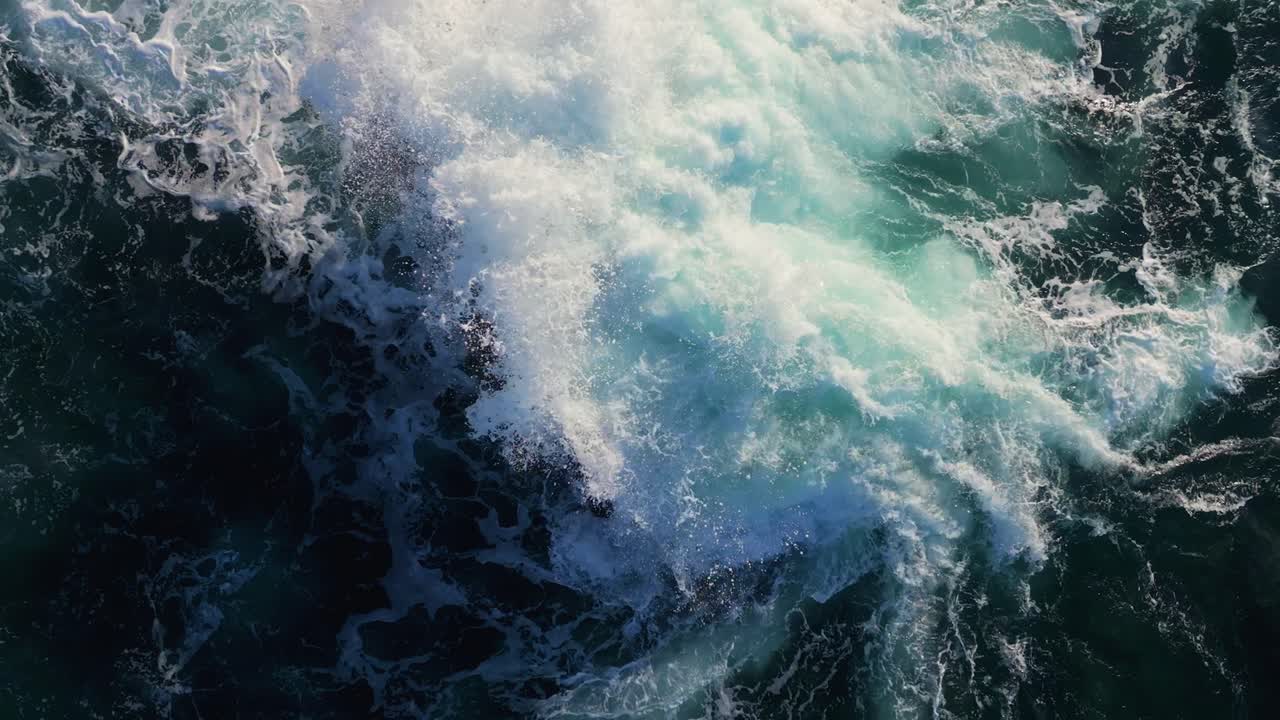Waves Crashing on a Rock in the Ocean - Aerial View