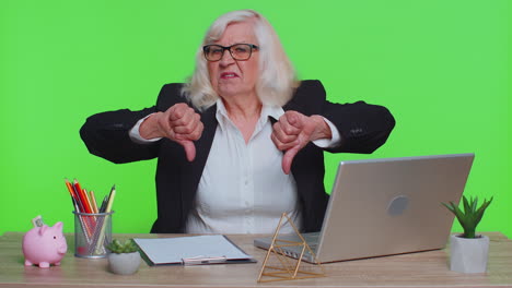 Upset-senior-business-woman-showing-thumbs-down-sign-gesture,-disapproval,-dissatisfied,-dislike