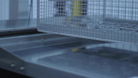 lattice container with metal billets moving along production line