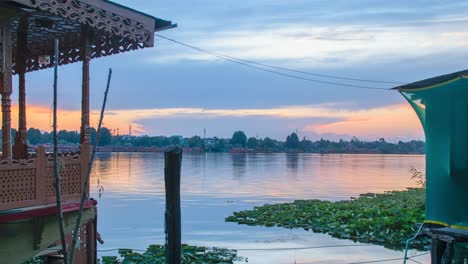 sunset timelapse at nigeen lake with houseboats in view and boats travelling across, srinagar, kashmir