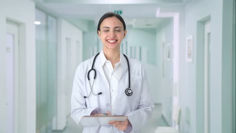 happy indian female doctor checking patient