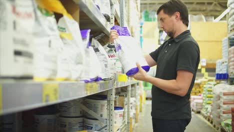 man shopping for gardening supplies in a store