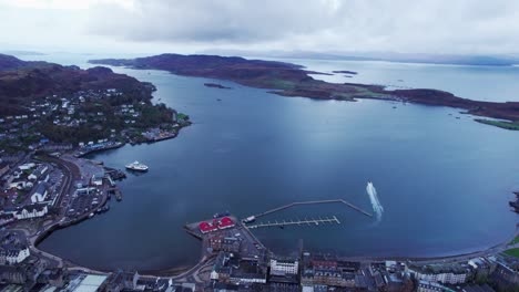 establisher shot of small town of oban in scotland, circle pan showing port