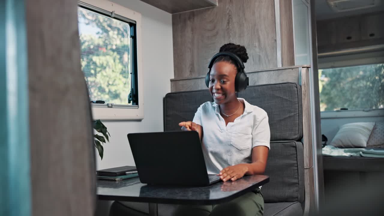 Young Woman Laughing on Video Call in Camper Van