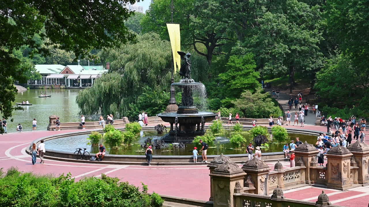 New York, USA, 28 July 2025: Sunny day at Bethesda Fountain. People stroll, relax, and engage in activities around the beautiful Bethesda Fountain in Central Park, Manhattan