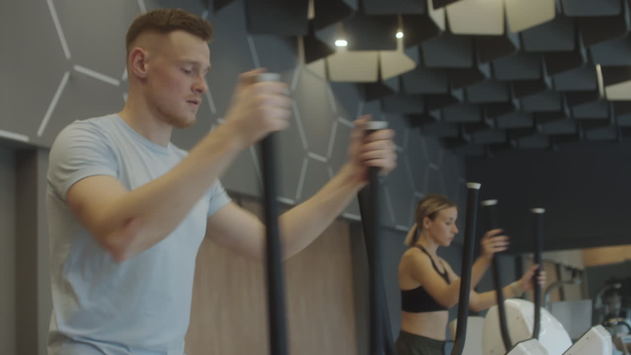 Man Exercising on Stepper Machine in Gym