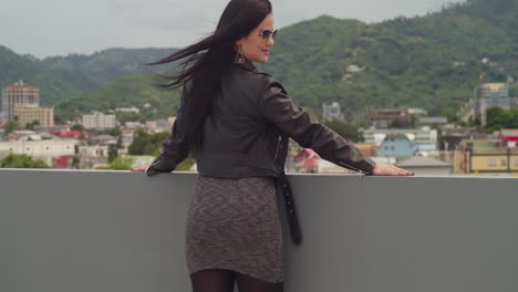 a woman is enjoying the rooftop vibes with a panoramic view of port of spain, trinidad