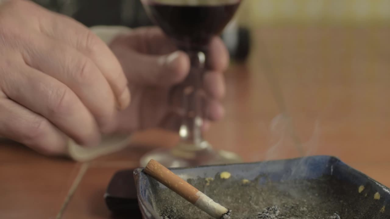 Hands with mobile phone and cigarette close up shot