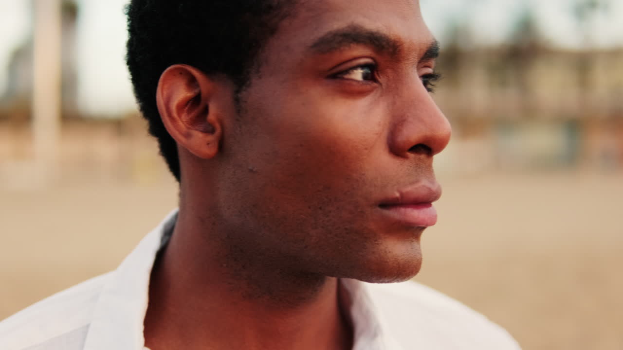 Close-up of Thoughtful Young African American Man Looking Away Outdoors
