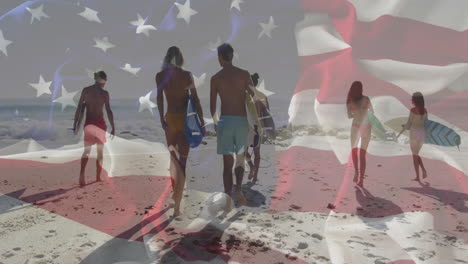 american flag animation over group of people walking on beach with surfboards