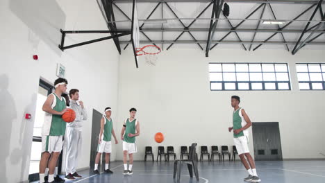 basketball players practicing shooting skills in gym, focusing on teamwork